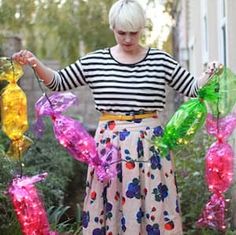 a woman standing in front of some balloons