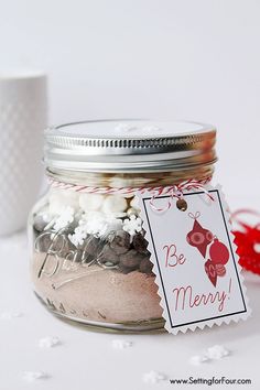 a jar filled with lots of different types of items next to a tag that says be merry