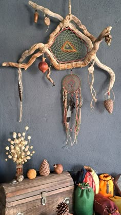 an assortment of items are hanging on the wall next to a trunk and pine cones