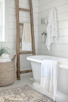 a bathroom with white walls and wood ladder in the corner, along with a rug on the floor