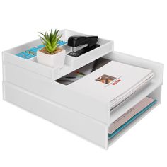 a white desk with two drawers and a potted plant on it's side