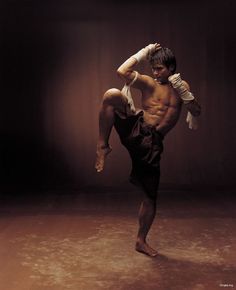 a shirtless man doing a handstand on the floor