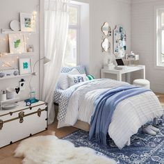 a bedroom with white walls and blue accents