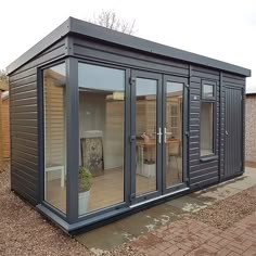 a small building with sliding glass doors on the outside