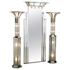 a tall mirror sitting next to two lamps