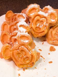 some kind of pastry on a plate with powdered sugar and icing around it