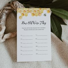 a bee themed baby shower game with honeycombs and greenery on the table