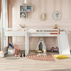 a child's bedroom with pink walls and white furniture