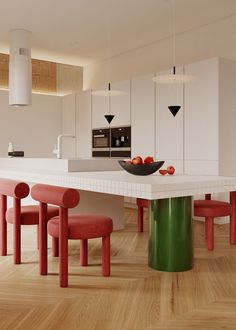 a modern kitchen with red and green chairs