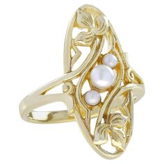 This ring presents a unique and eye-catching vintage-inspired design. The overall impression is one of elegance and artistic flair. The ring has an intricate, three-dimensional design with overlapping curved gold elements forming an elongated, abstract shape reminiscent of a stylized flower or leaf, likely the "Natural Triple Pearl" are nestled within the gold framework providing a subtle contrast to the gold. This ring would be suitable for formal events or as a standout accessory for a fashion Sculptural Jewelry, Vintage Inspired Rings, Pearl Vintage, Carved Ring, Abstract Shape, Modern Ring, Garnet Gemstone, Natural Opal, Natural Pearls