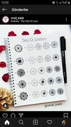 a spiral notebook with lots of different types of circles and flowers on the page, next to a pen