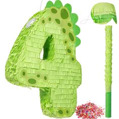 the number four is made out of green paper and has sprinkles on it