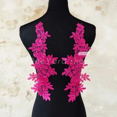 a black mannequin with pink flowers on it's chest and neckline