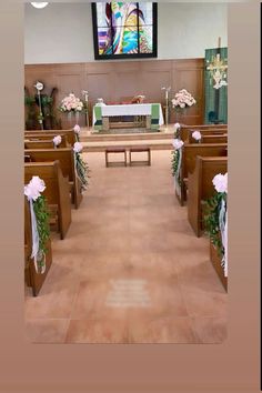 the inside of a church with pews and flowers