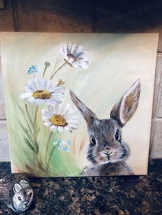 a painting of a rabbit with daisies in the foreground