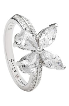 a white gold ring with two pear shaped diamonds on the side and an engraved name