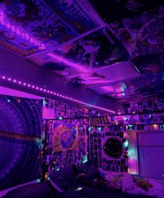 a bedroom with purple lights and decorations on the ceiling