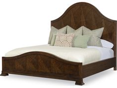 a bed with wooden headboard and pillows on top of it, against a white background