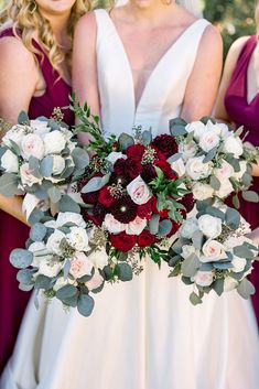 the bridesmaids are holding their bouquets with red and white flowers