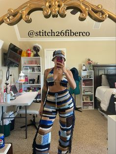 a woman taking a selfie in front of a mirror with the words stitch and fiber on it