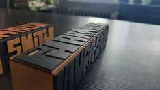 two wooden blocks sitting on top of a table next to each other with the word truth written in it