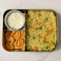 a metal tray filled with rice and oranges next to a bowl of yogurt