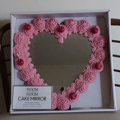 a cake shaped like a heart in a box with a mirror on the front and side