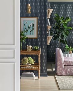 a living room filled with furniture and a potted plant