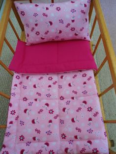 two baby cribs with pink and blue sheets on them