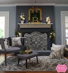 a living room filled with furniture and a fire place in front of a brick wall