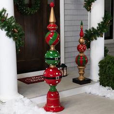 three christmas ornaments on top of each other in front of a house