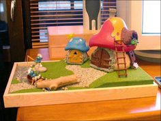 a wooden table topped with toy figurines next to a window