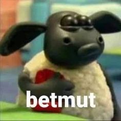 a black and white sheep holding a red heart with the words betmut on it