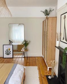 a bedroom with wood floors and white walls