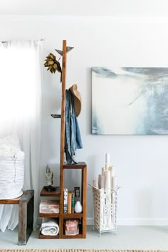 a white room with a shelf, hat rack and other items