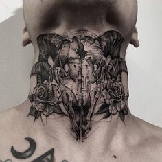 a man's neck with an elephant skull and roses tattoo on the back of his neck