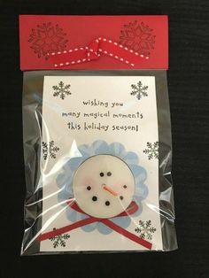 a christmas card with a snowman on it and a red ribbon around the neck