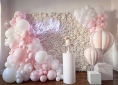 balloons and candles are arranged in front of a baby shower backdrop