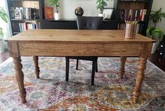 a wooden table sitting on top of a rug