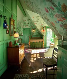 an attic bedroom with green walls and floral wallpaper on the ceiling, along with a bed