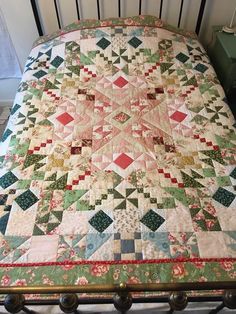 a bed with a quilt on top of it