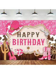 a happy birthday sign with cowboy boots and pink shoes on the floor in front of a western theme backdrop