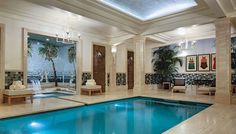 a large indoor swimming pool with mirrors on the wall