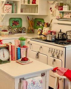 a kitchen with an old fashioned stove and lots of clutter on the counter top