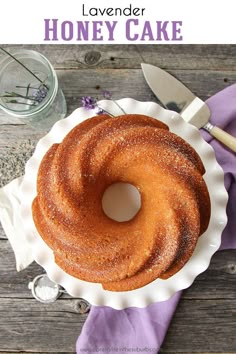 a bundt cake sitting on top of a white plate next to a purple napkin