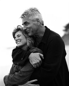 an older couple embracing each other in black and white