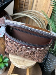 Carry your everyday essentials in style with our Tooled Fanny Packs! Made from premium tooled leather, with cowhide top and white buck-stitch accents, this fashionable pack will have you feeling fly and looking sharp. It even comes with a handy back zipper, perfect for quick access to your goodies. Luxury Leather Western Bags, Tooled Leather Yeti Sleeve, Western Essentials, Cross Body Bag Pattern, Leather Patterns, Western Bedroom, Horse Western, Tooled Leather Belts, Cowgirl Accessories