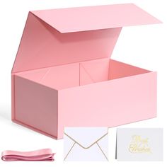 an open pink gift box with its lid opened next to it's matching napkins