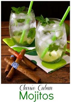 two glasses filled with mojitos sitting on top of a table next to cinnamons