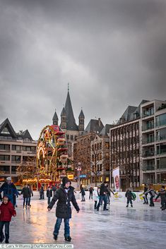 people skating on an ice rink in the city